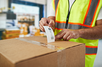 RFID label being placed on a box
