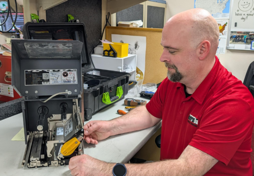 Service Tech Fixing Open Printer